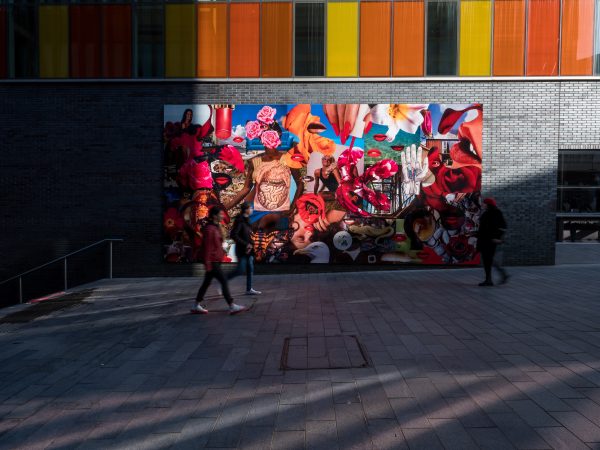 A large photo collage covering a bricked wall in Liverpool ONE.