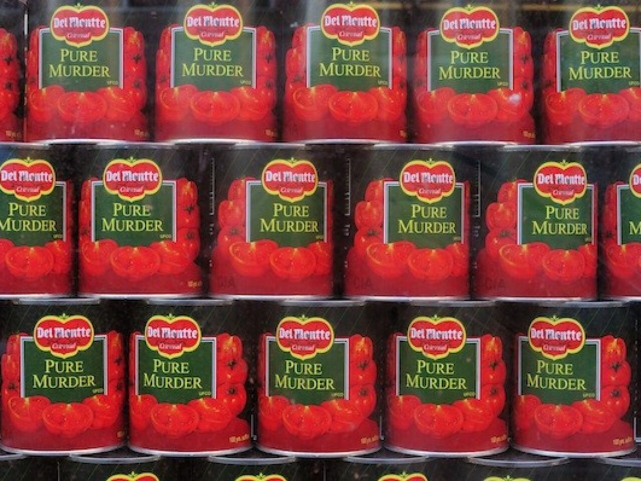 A close up image of stacked tins of tomatoes