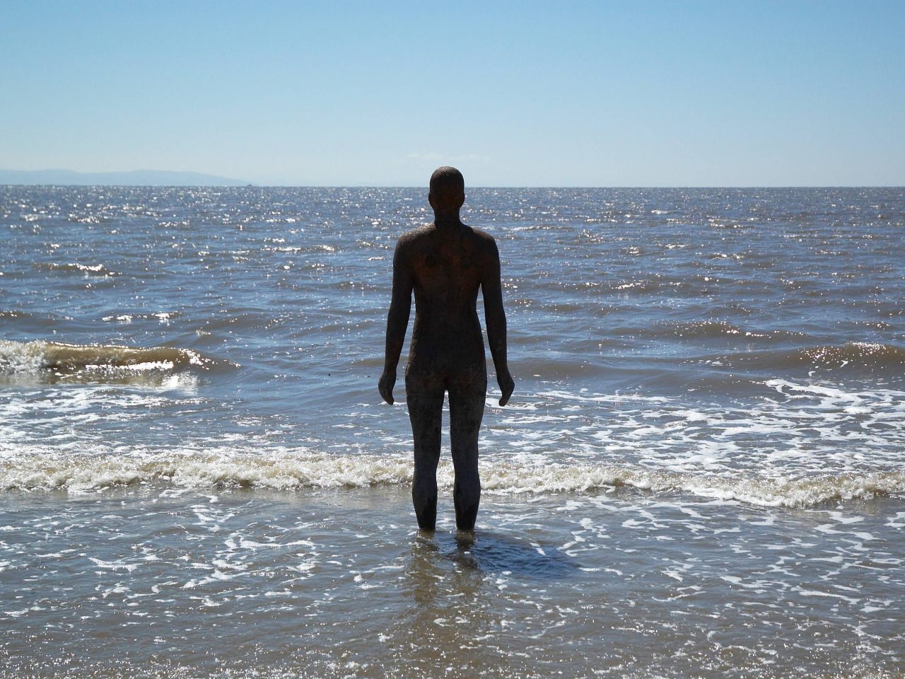 A beach scape with a life-size cast-iron mould of the artists own body