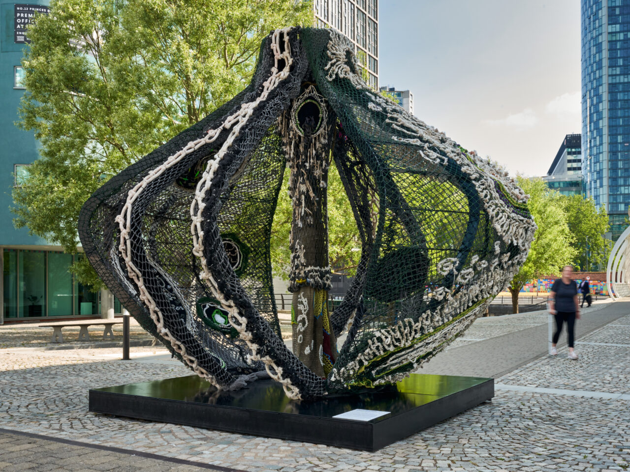 A large-scale sculpture ⁠in the shape of a vessel. The sculpture is created with steel and recycled fishing nets with hand-woven embellishment